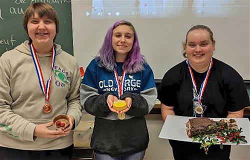 students post with desserts